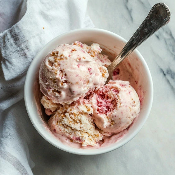 A bowl of ice cream with a spoon in it.