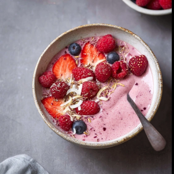 A bowl of berries and cream.