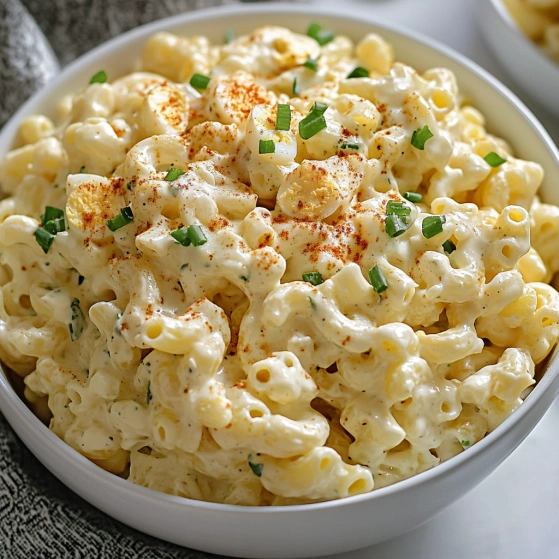 A bowl of macaroni and cheese with green onions.