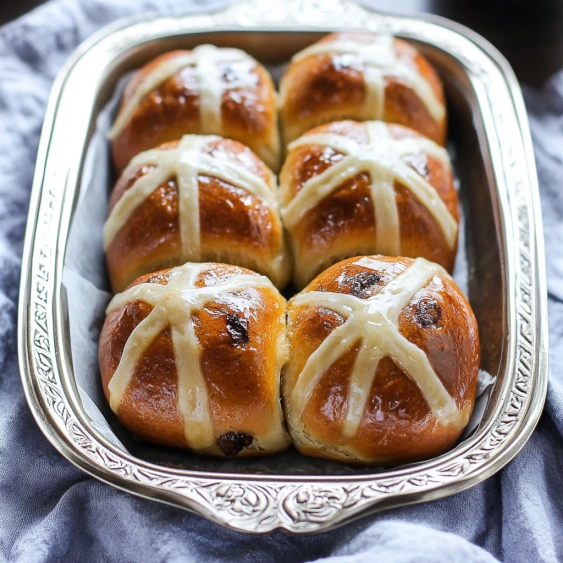 A silver tray with six rolls of bread.