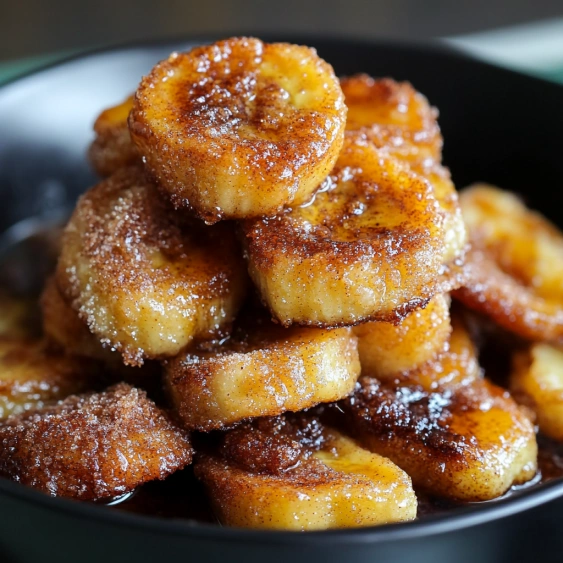 A bowl of sugar coated bananas.