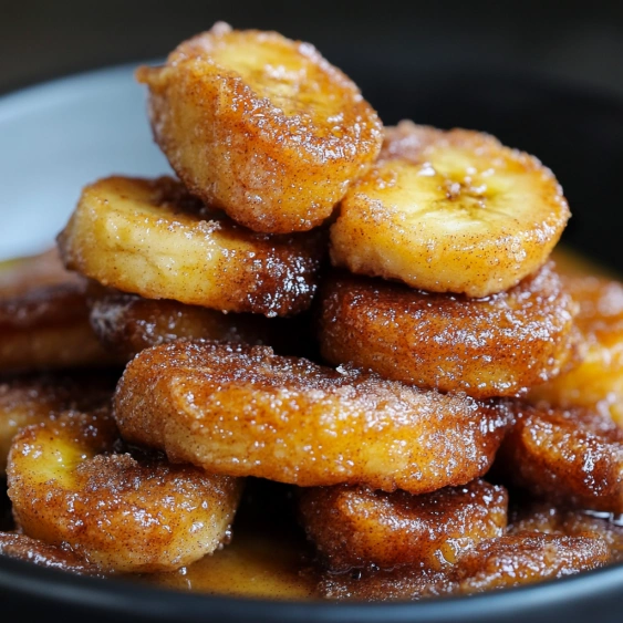 Bowl of doughnuts with sugar on top.