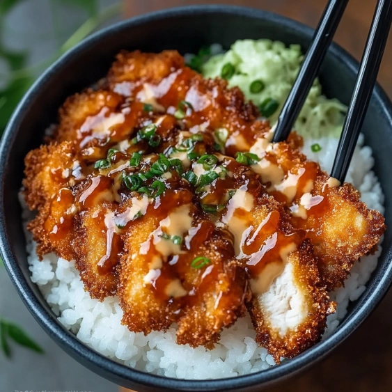 A bowl of food with rice and chicken.