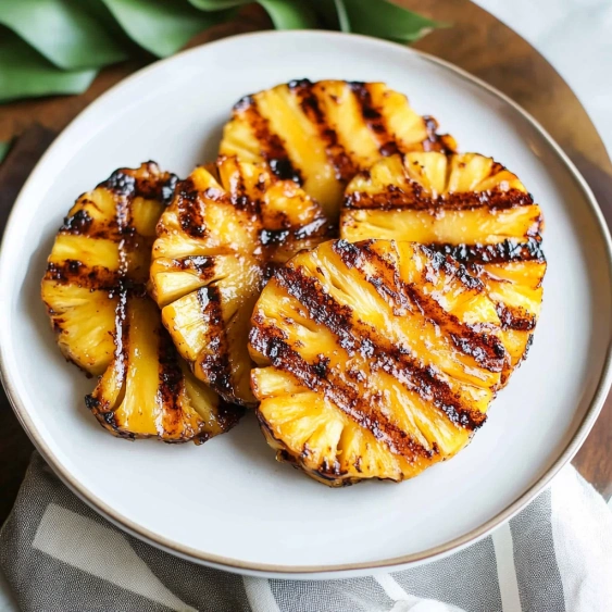 A plate of grilled pineapple slices.