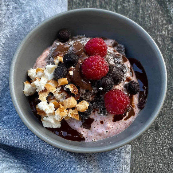 A bowl of chocolate and raspberry ice cream.