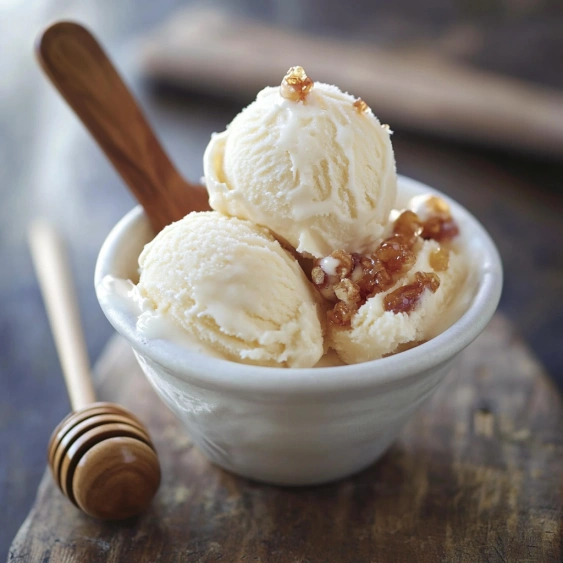 A bowl of ice cream with a wooden spoon.