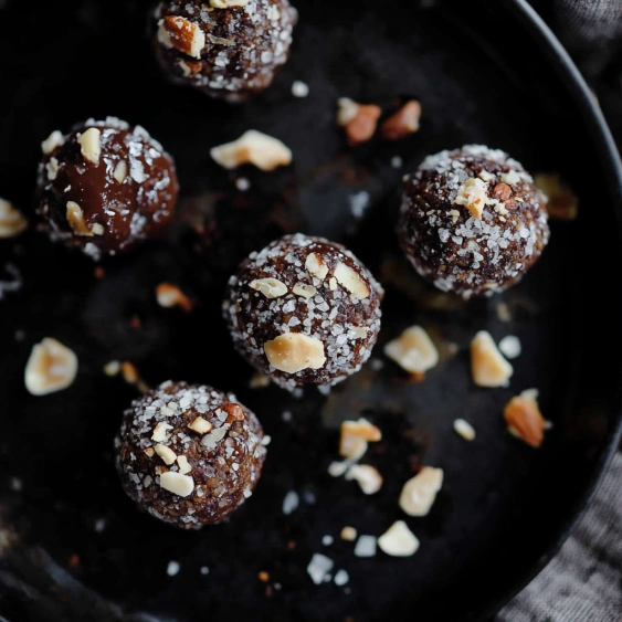 A plate of chocolate covered almonds.