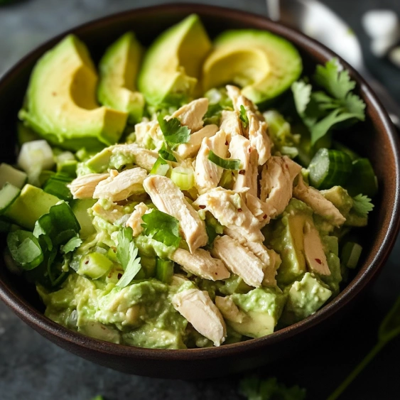 A bowl of chicken and avocado salad.
