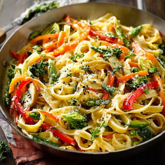 A pan of pasta with vegetables.