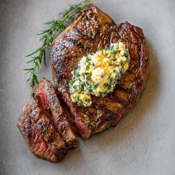 A piece of meat with a blue sauce on it.