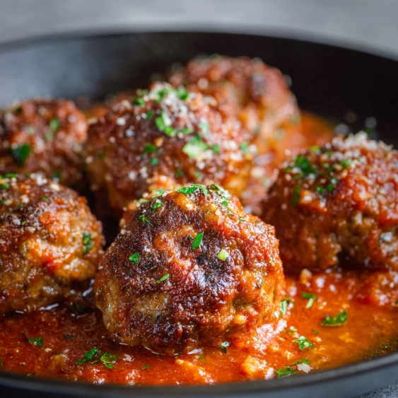 A bowl of meatballs in a tomato sauce.