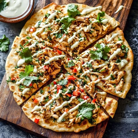 A pizza with chicken and vegetables on it.